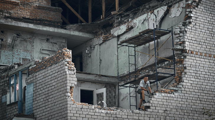 Rommá lőtt házból néz ki egy férfi Nikopolban 2022. augusztus 15-én, miután orosz rakétatámadás érte a dél-ukrajnai várost. Fotó: MTI/AP/Kosztyantin Liberov